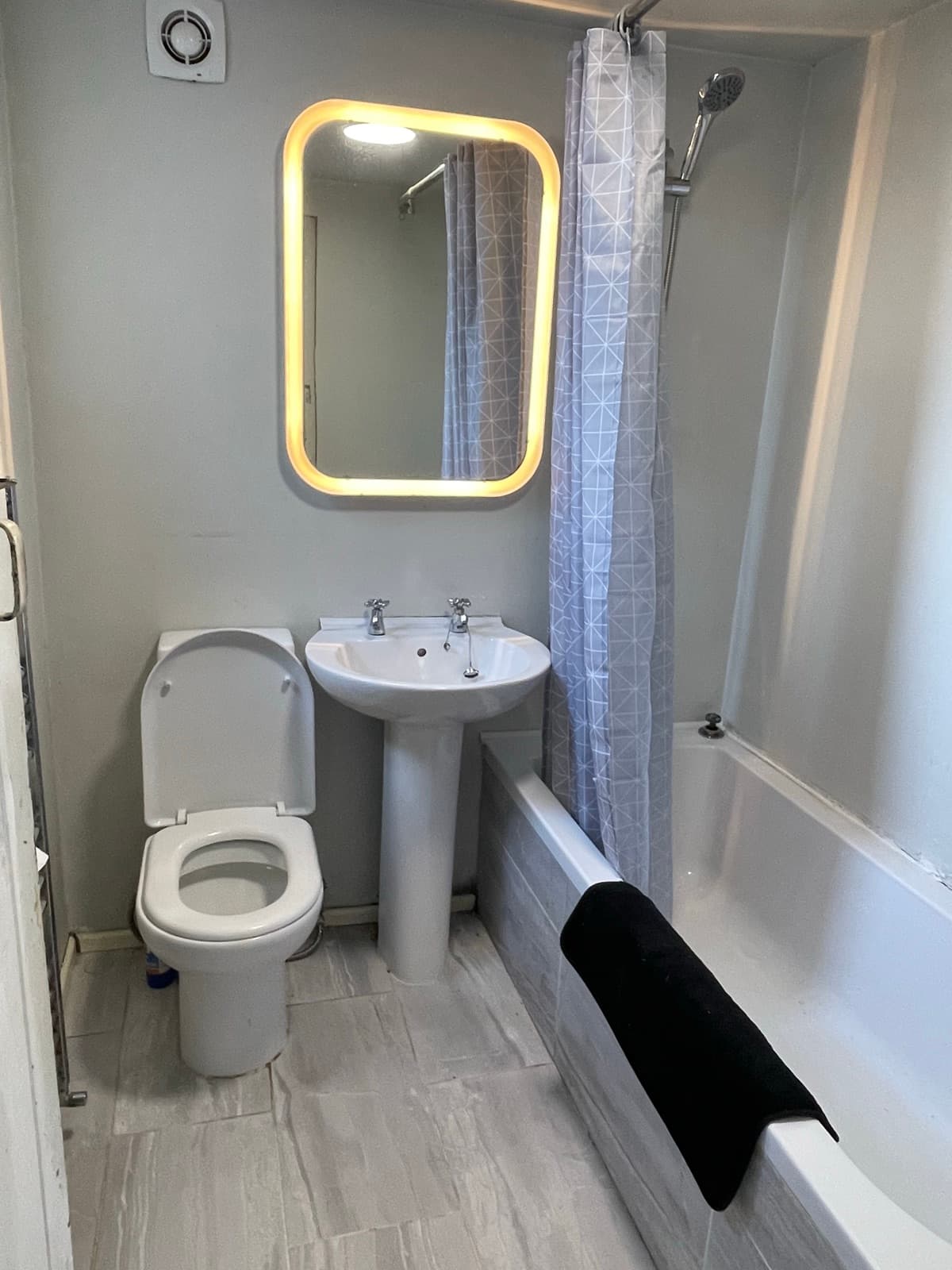 Family bathroom with bath and shower over