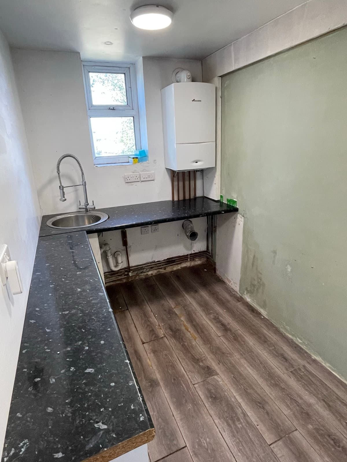 Utility room with sink and plumbing